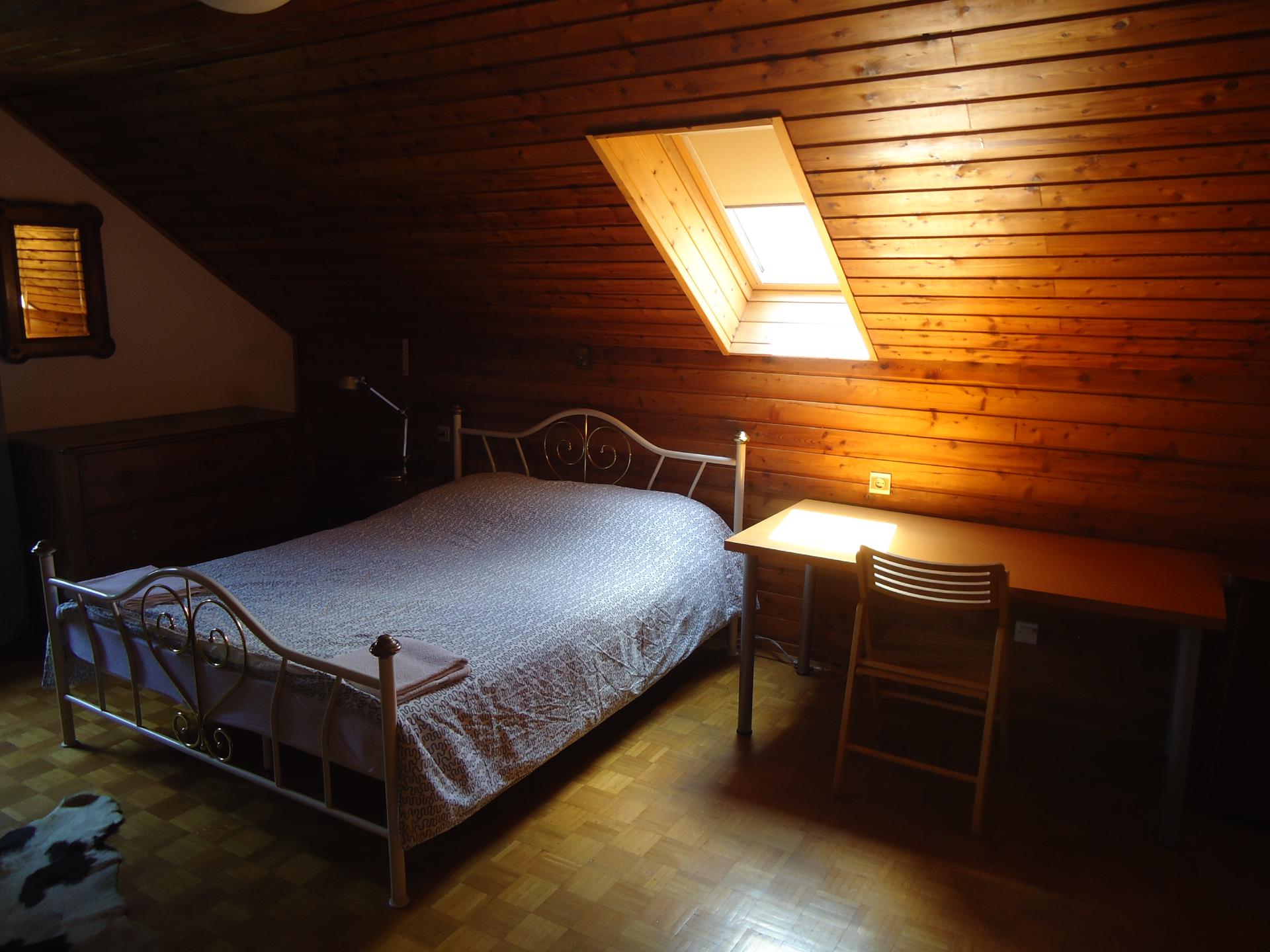 Two bedrooms and a long sitting room with a tile stove on the upper floor of the farmhouse. South-facing balcony over the orchard.