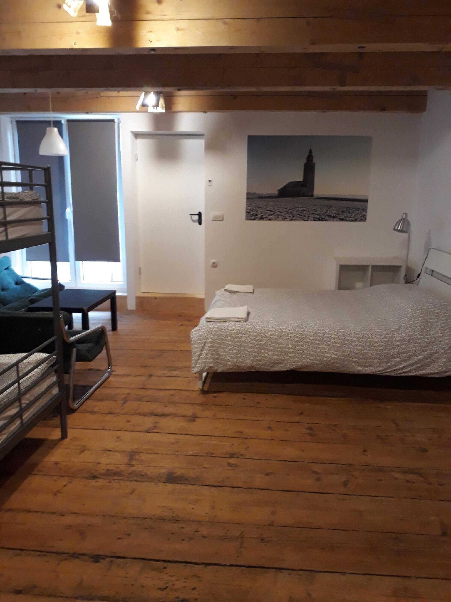 A private room on the ground floor of the converted barn — two bunk beds and one double bed, garden view, shared bathroom.